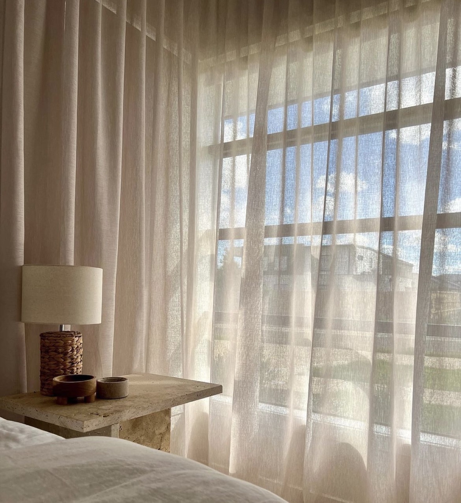 Elegant sheer drapery in a sunlit bedroom by Luxe Blinds New York